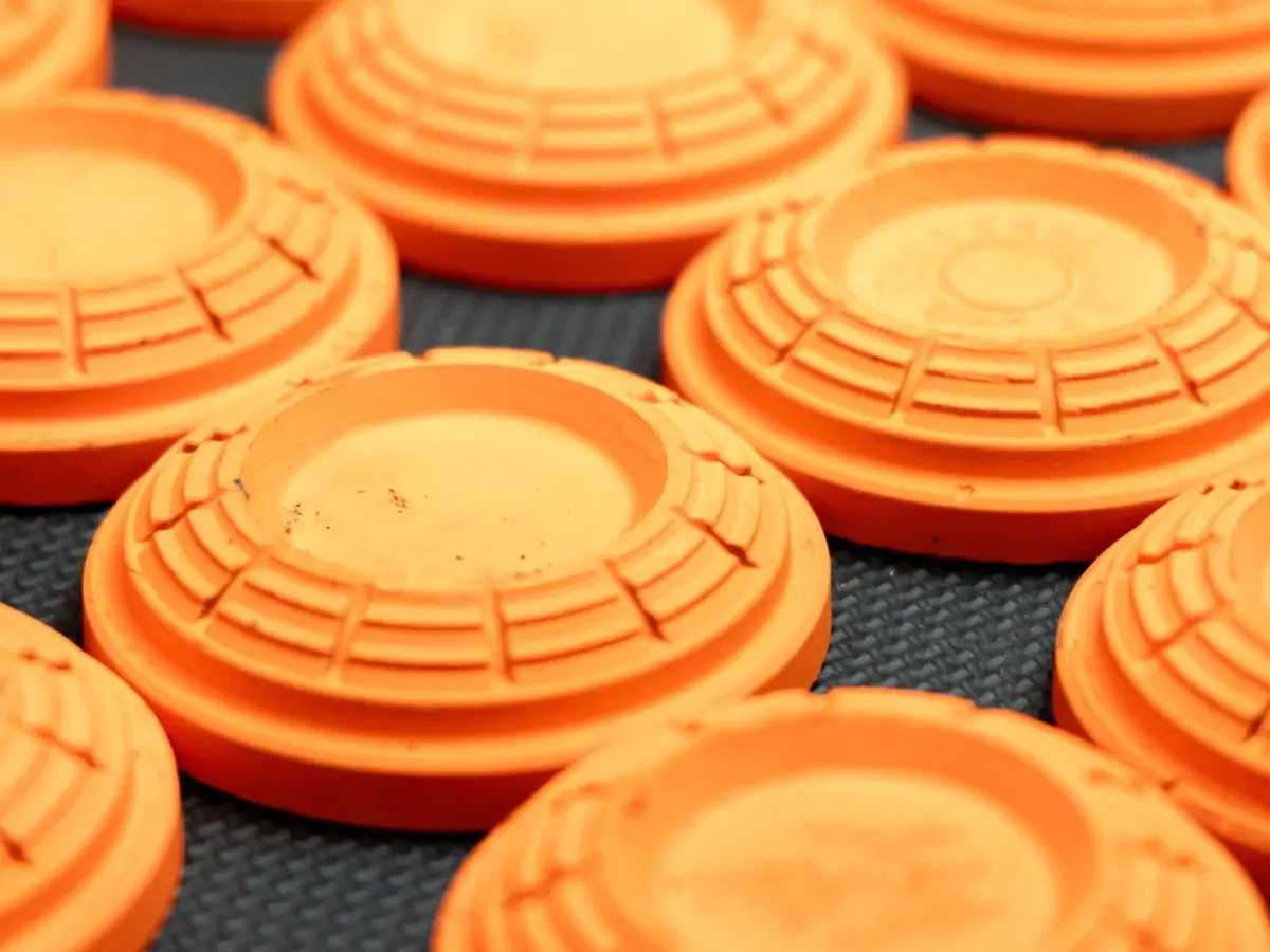 Orange clay pigeons on a dark surface