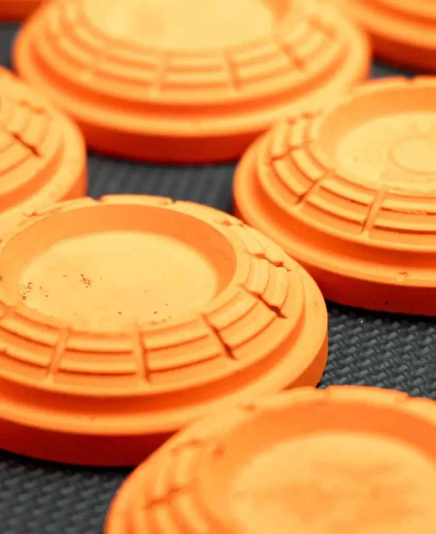 Orange clay pigeons on a dark surface