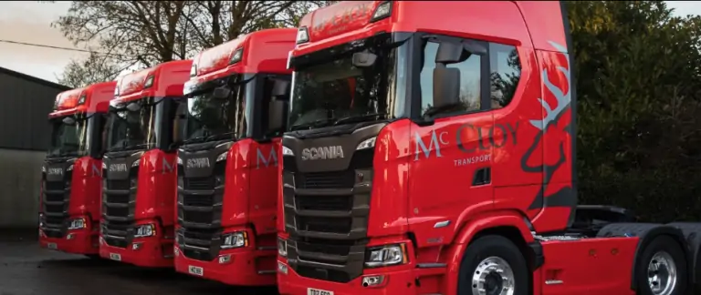 Red Mc Cloys Transport trucks parked in a row
